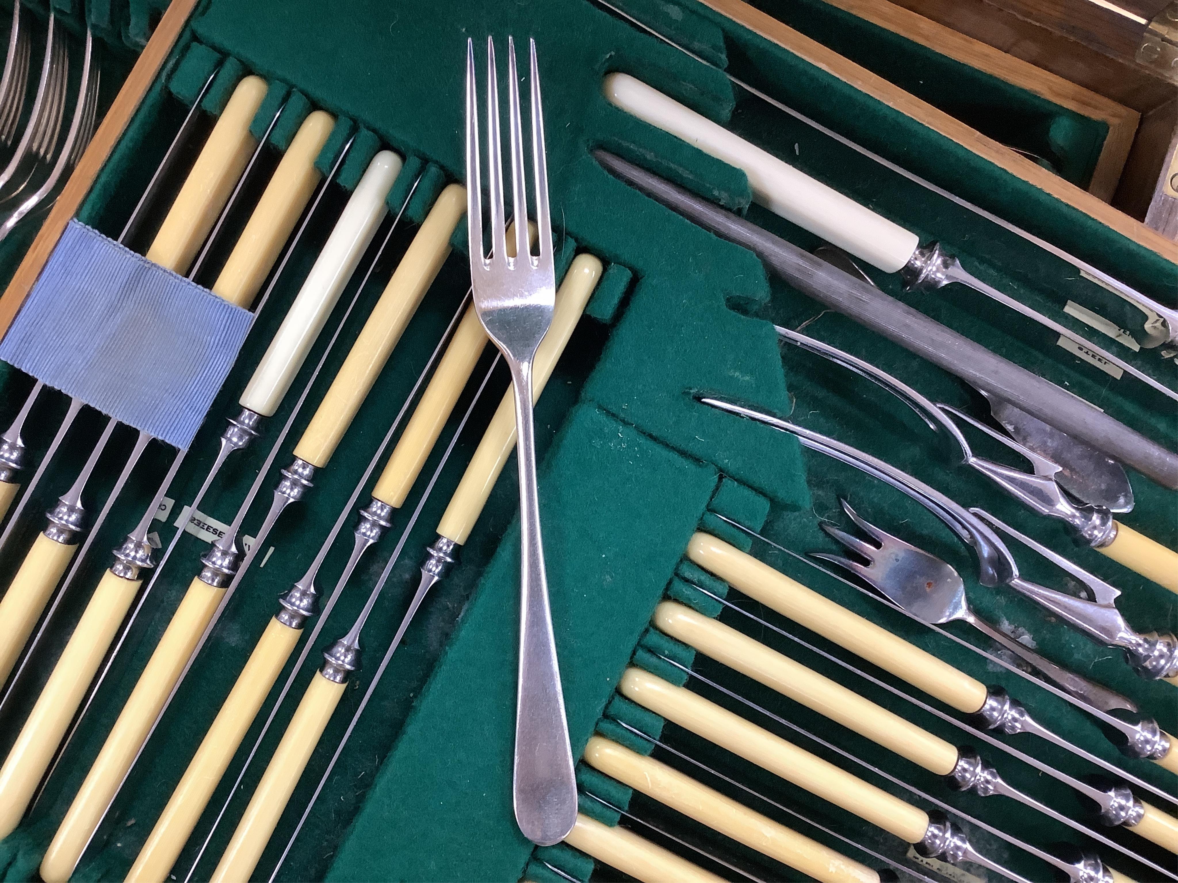 An Elkington & Co plated Old English pattern canteen of cutlery, oak cased, 48cm wide. Condition - fair